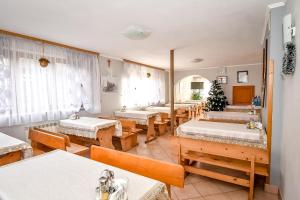 a room with several beds and tables and windows at U Cudzicha in Zakopane