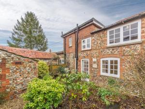 an old brick house with white windows and plants at 2 Bed in Little Walsingham KT158 in Little Walsingham