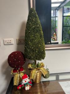 a christmas tree on a table with bows at Kata Gardens Apartments in Kata Beach