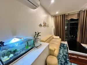 a living room with a fish tank and a couch at Skyhome in Gia Lâm Pho