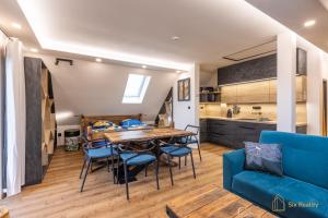 a kitchen and dining room with a table and chairs at Apt. Plešivec in Abertamy