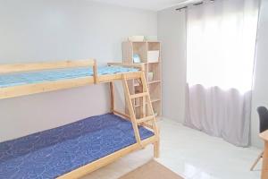 a room with a bunk bed and a ladder at 2B Tiny Home in Iba Zambales in Iba
