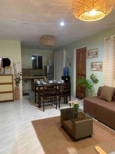 a living room with a couch and a dining room at 2B Tiny Home in Iba Zambales in Iba