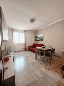 a living room with a red couch and a table at Scabi Apartments in Trapani