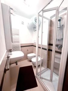 a bathroom with a glass shower and a toilet at Scabi Apartments in Trapani