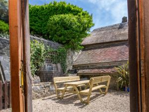 a wooden bench sitting in front of a building at 3 Bed in Lulworth Cove DC023 in West Lulworth