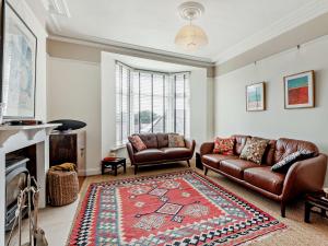 a living room with two leather couches and a rug at 3 Bed in Portland DC031 in Portland