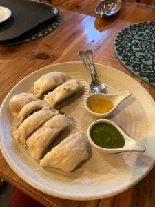 a plate of food with dumplings on a table at Boho Grove Cafe & Stay, Tirthan Valley in Banjār