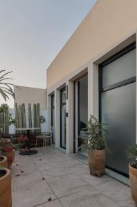 a patio with potted plants next to a building at Céntrico Live in Oaxaca City