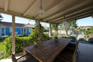 a wooden table and chairs on a patio at Stancija Čabrunići in Čabrunići +48 photos