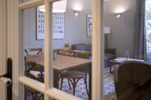 a dining room with a wooden table and chairs at Bcn Paseo De Gracia Rocamora Apartment in Barcelona