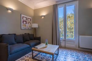 a living room with a couch and a table at Bcn Paseo De Gracia Rocamora Apartment in Barcelona