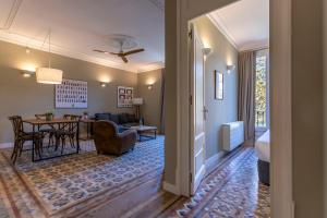 a living room with a table and a dining room at Bcn Paseo De Gracia Rocamora Apartment in Barcelona