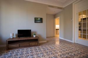 a living room with a flat screen tv on a wall at Bcn Paseo De Gracia Rocamora Apartment in Barcelona