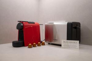 a red and white microwave next to a toaster at Bcn Paseo De Gracia Rocamora Apartment in Barcelona