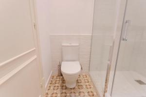 a bathroom with a toilet and a shower at Bcn Paseo De Gracia Rocamora Apartment in Barcelona