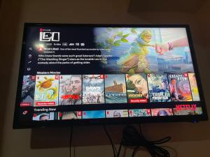 a television screen with a bunch of movies on it at Great 1BR Aqua Livingstone with Netflix, Pool & Gym in Manila