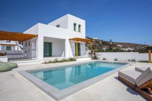 a villa with a swimming pool in front of a house at Onar Villas Skyros in Skiros