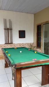 a pool table with balls on top of it at Casa com piscina in Armacao dos Buzios