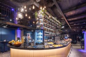 a restaurant with a counter with food on it at Pytloun Boutique Hotel Prague in Prague