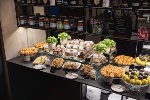 a buffet with many different types of food on display at Pytloun Boutique Hotel Prague in Prague