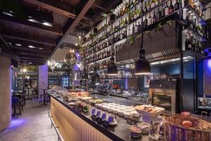 a restaurant with a counter with food on it at Pytloun Boutique Hotel Prague in Prague