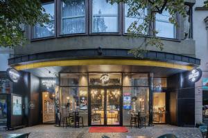 a store front of a building with tables and chairs at Pytloun Boutique Hotel Prague in Prague