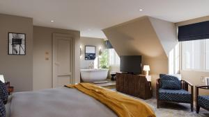 a bedroom with a bed and a tv and a bathroom at White Horses by Everly Hotels Collection in Rottingdean