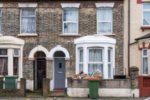 a brick house with a door and a window at LiveStay - 5 Bedroom House in Stratford in London