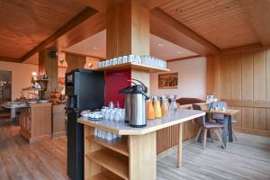 a kitchen with a counter with a coffee pot on it at Hotel Alpenglühn in Füssen