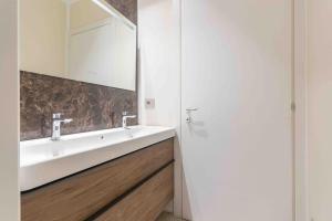 a bathroom with a white sink and a mirror at Gallery Loft 1 [Turin city center] in Turin