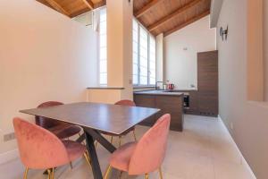 a kitchen with a table and chairs in a room at Gallery Loft 1 [Turin city center] in Turin
