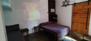 a purple bench in a room with a door at La Minimalista in Bagac +6 photos