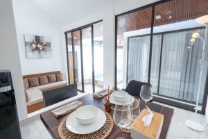 a living room with a dining table and a living room at The Lavana De Mello's Villa Seminyak -1 Bedroom Villa with Private Pool in Kerobokan