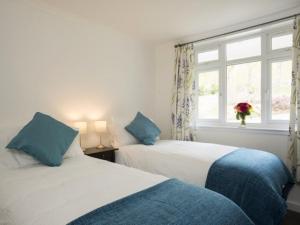 two beds in a room with a window at 2 Bed in Pitlochry CA084 in Struan