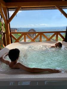 two boys in a jacuzzi in a swimming pool at Osada Na Ochodzitej in Koniaków