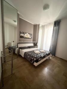 a bedroom with a bed and a large mirror at Scabi Apartments in Trapani