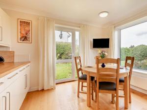 a kitchen with a table and chairs and a window at 4 Bed in Studland 75639 in Studland