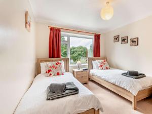 two beds in a room with a window at 4 Bed in Studland 75639 in Studland