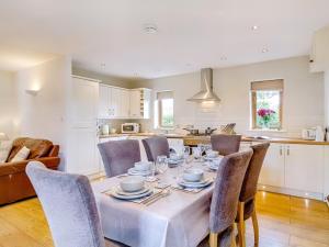 a kitchen and dining room with a table and chairs at 3 Bed in Stoborough DC157 in Stoborough