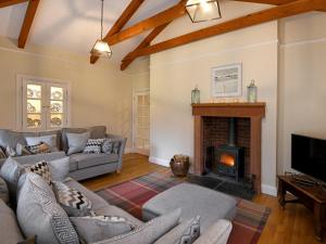 a living room with couches and a fireplace at 3 Bed in Annan 75355 in Annan