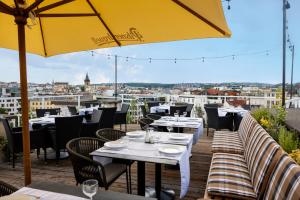 a restaurant with tables and chairs and an umbrella at Pytloun Boutique Hotel Prague in Prague