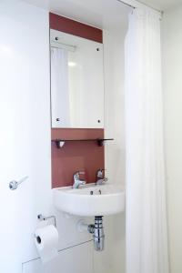 a bathroom with a sink and a mirror at Keynes College Budget Accommodation in Canterbury