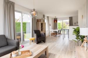 a living room with a couch and a table at Summio Zeeland Village in Scharendijke