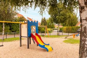 a playground with a slide in a park at Summio Zeeland Village in Scharendijke