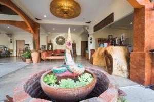 a living room with a large flower pot in the middle at BOSS HOTEL CHIANGMAl in Chiang Mai
