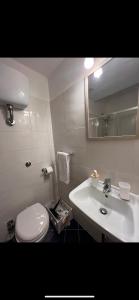 a bathroom with a white toilet and a sink at Guest House Biondi Cavour in Rome