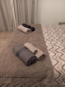 two towels are on a bed with a rug at Casa Vacanza Rimini in Rimini +29 photos