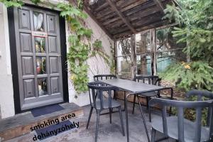 a patio with a table and chairs and a window at URBAN in Old Town (Kecskemét) in Kecskemét