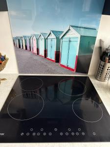 a view of a row of beach huts at Central Hove Quiet Top Floor Flat with Terrace in Brighton & Hove